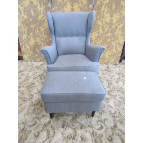 1333 - A contemporary wing-back button-back elbow chair with associated foot stool (2)