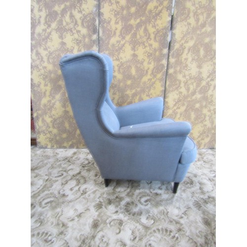 1333 - A contemporary wing-back button-back elbow chair with associated foot stool (2)