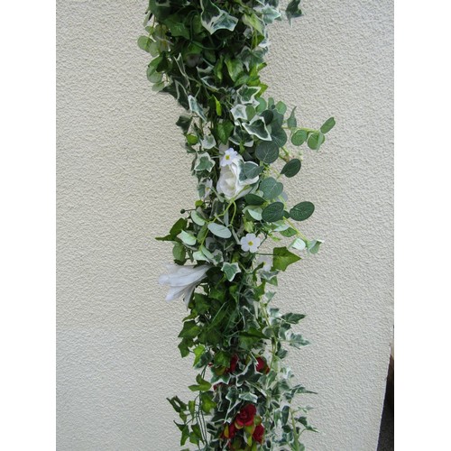 1561A - A painted square tubular steel framed wedding arch with trailing artificial ivy and floral detail, a... 