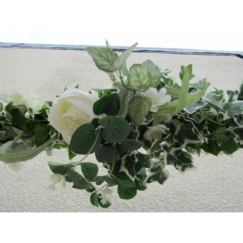 1561A - A painted square tubular steel framed wedding arch with trailing artificial ivy and floral detail, a... 