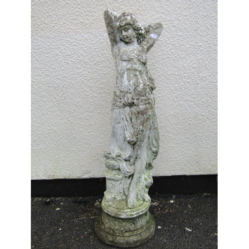 1562 - A painted and weathered cast composition stone garden statue in the form of a maiden with long flowi... 