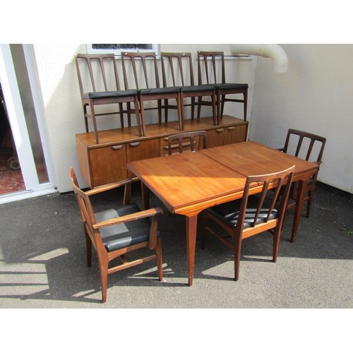 1574A - A Younger mid century teak dining suite, comprising sideboard, dining table and eight dining chairs