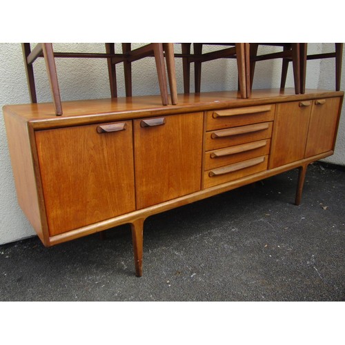 1574A - A Younger mid century teak dining suite, comprising sideboard, dining table and eight dining chairs