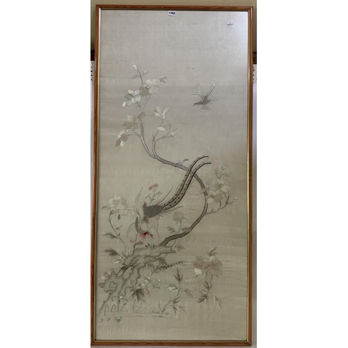 1703 - A 20th century Chinese silk embroidery depicting a pheasant perched on a branch adorned with flowers... 