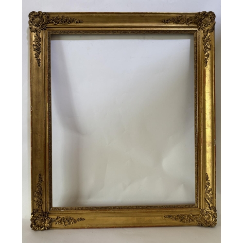 1705 - A 19th century gilt picture frame with scrolling foliate gesso corner mouldings, fitting dimensions ... 