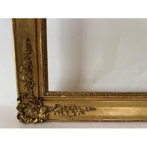 1705 - A 19th century gilt picture frame with scrolling foliate gesso corner mouldings, fitting dimensions ... 