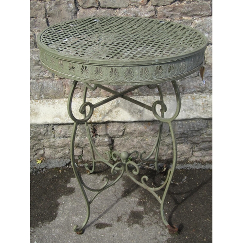 1081 - A decorative sage green painted cast metal garden table, the circular lattice panelled top with pier... 