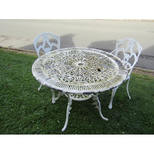 1083 - A painted and weathered cast aluminium garden terrace table with radiating decorative circular pierc... 