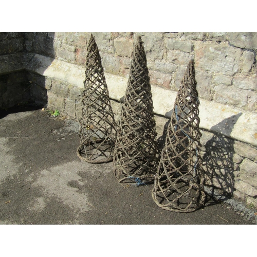 1110 - Four weathered woven wicker and iron wire work garden obelisks of pointed conical form, each 79cm hi... 