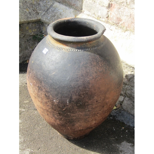 1114 - A large burnished terracotta vase / planter of baluster form with pinched collar, 65cm high.