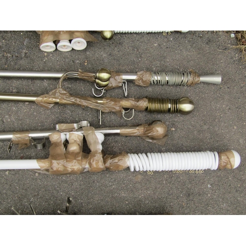 1135 - A group of curtain poles and fittings, painted and brass, examples.