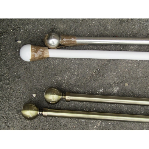 1135 - A group of curtain poles and fittings, painted and brass, examples.