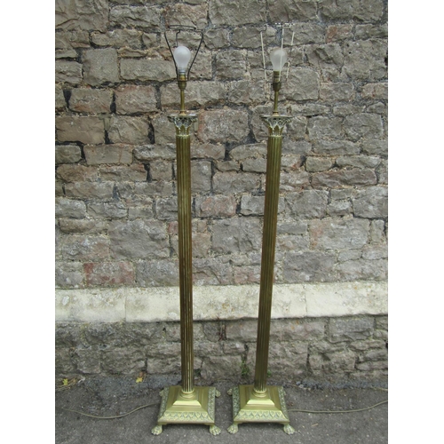 1146 - A pair of Edwardian brass standard lamps in the form of fluted columns with Corinthian capitals, rai... 