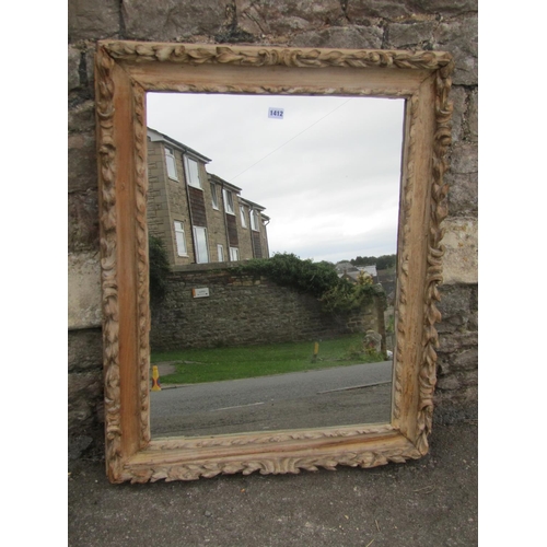 1412 - A 19th century carved limed wood framed wall mirror with foliate borders, 92 x 71cm