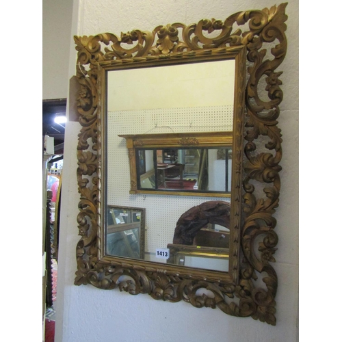 1413 - A Florentine style gilt framed wall mirror, with pierced foliate and floral borders, 66 x 50cm.