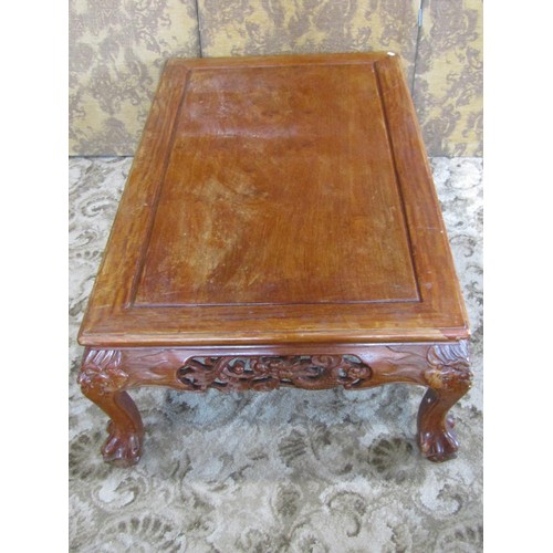 1227 - A Chinese carved hardwood low occasional/coffee table with bevelled top above a carved and pierced f... 