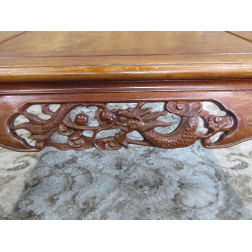 1227 - A Chinese carved hardwood low occasional/coffee table with bevelled top above a carved and pierced f... 