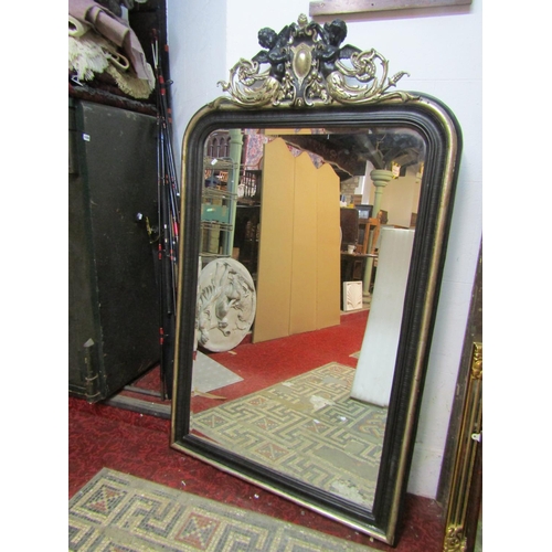 1406 - A large decorative arched wall mirror with figural surmount 173 x 103cm.