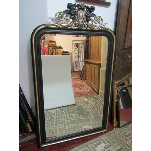 1406 - A large decorative arched wall mirror with figural surmount 173 x 103cm.