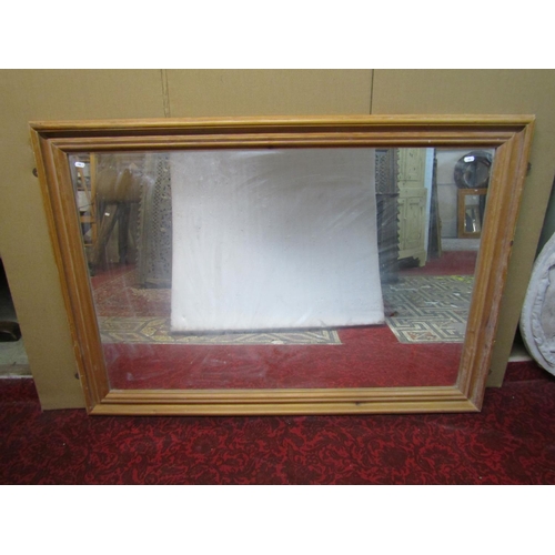 1427 - A large pine framed wall mirror, 98 x 138cm.