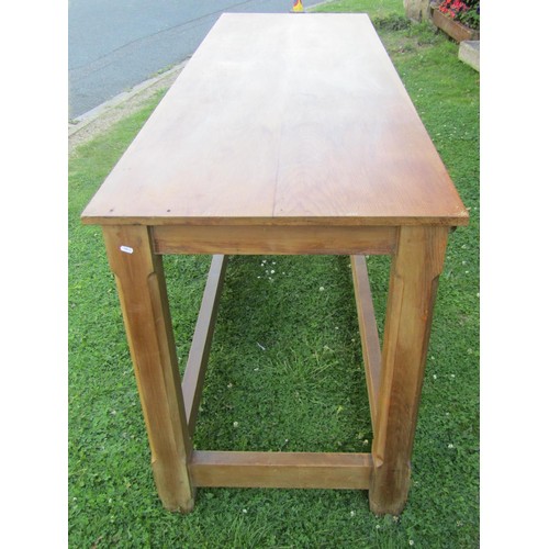 1237 - A pine hall table in the Cotswold School style, with chamfered squared legs united by stretchers, wi... 