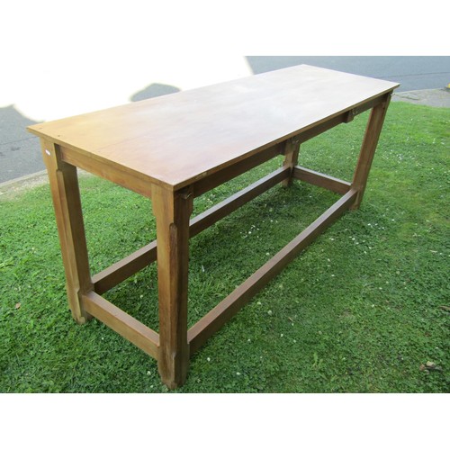 1237 - A pine hall table in the Cotswold School style, with chamfered squared legs united by stretchers, wi... 