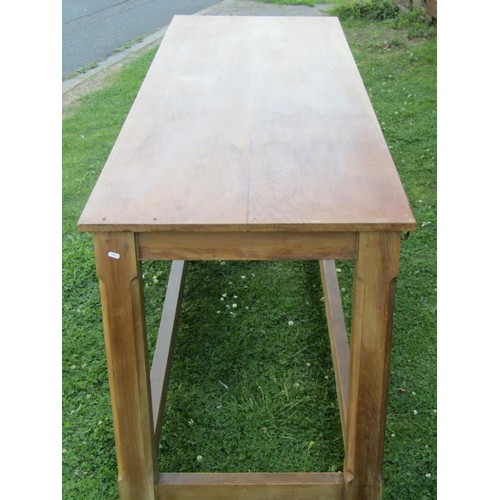 1237 - A pine hall table in the Cotswold School style, with chamfered squared legs united by stretchers, wi... 