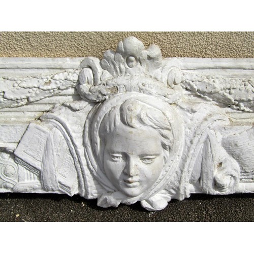 1597 - A large plaster panel / frieze, cantered with a maiden’s mask  flanked by garlands, 54 x 180cm