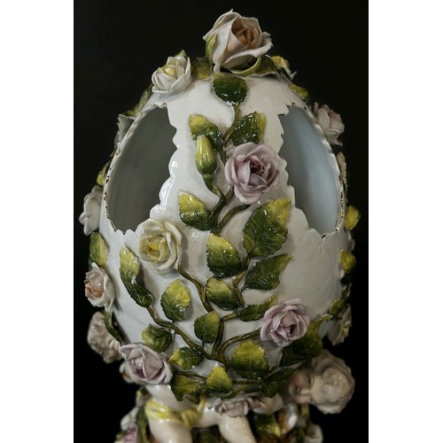 166 - Meissen style porcelain egg decorated with cherubs and roses etc.