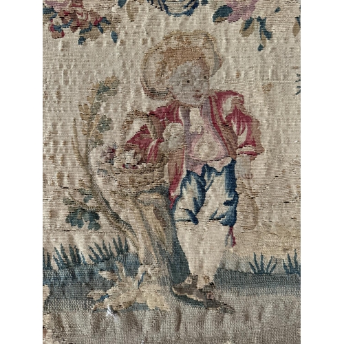 1688 - A French Aubusson tapestry titled 'Farmer's Boy', depicting a young man holding a basket while leani... 