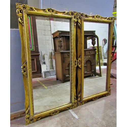 1590 - A pair of reproduction carved gilt framed wall mirrors, each 153 x 83cm (2)