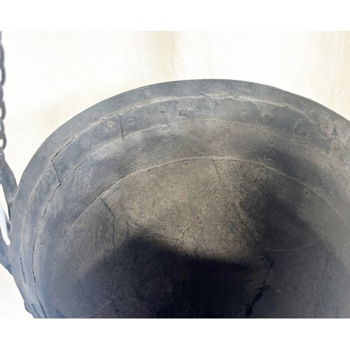 554 - A helmet shaped well bucket with riveted panels, 27cm diameter