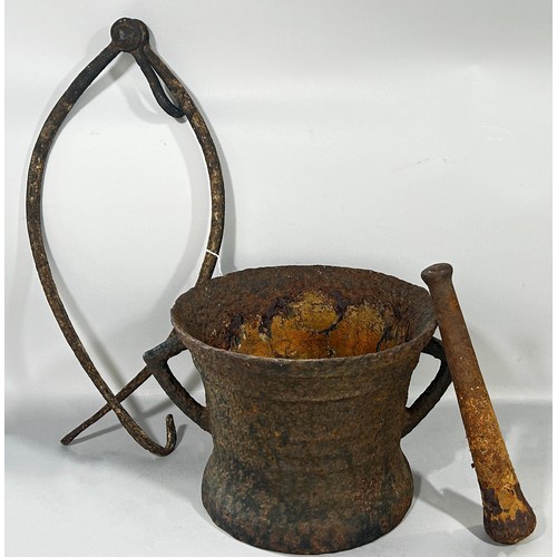 555 - A substantial early cast iron pestle and mortar 26cm diameter, together with  pair of iron grips