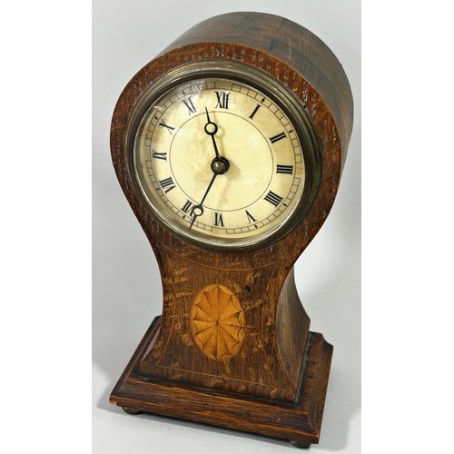 409 - A small Edwardian inlaid oak balloon mantle clock, 21 cm high