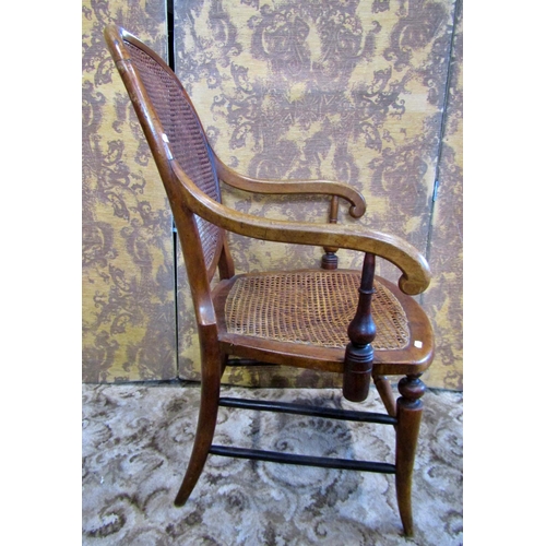 1235 - A Victorian elbow chair with cane panelled seat and back.