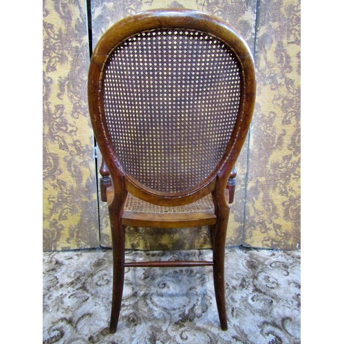 1235 - A Victorian elbow chair with cane panelled seat and back.