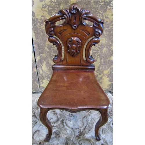 1317 - A Victorian mahogany shield back carved hall chair