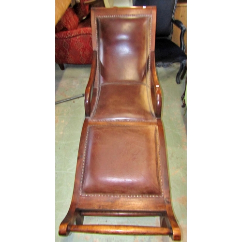 1359 - A good teak framed lounger with upholstered seat in buttoned and stitched weathered tan leather cove... 