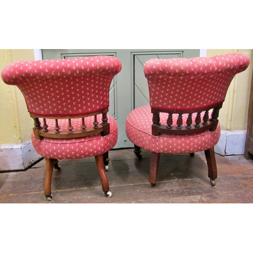 1462 - A pair of Victorian walnut drawing room chairs with spindle moulded backs on turned supports