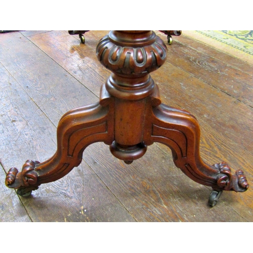 1505 - 19th century mahogany centre table, the shaped outline raised on a stretcher base with scrolled term... 