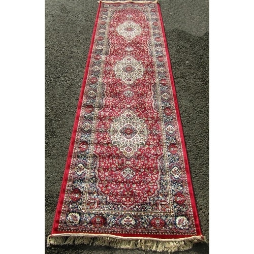 1797 - A Kashmir runner with a full pile red ground, 300cm x 80cm