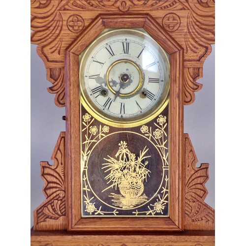 403 - An American ‘Gingerbread’ cased clock, 58 x 25cm.