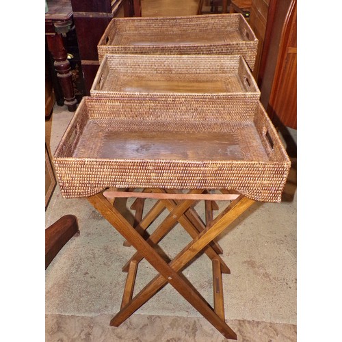 1205 - Three similar Butler’s woven cane trays / occasional tables, all with folding stands, with labels Ta... 