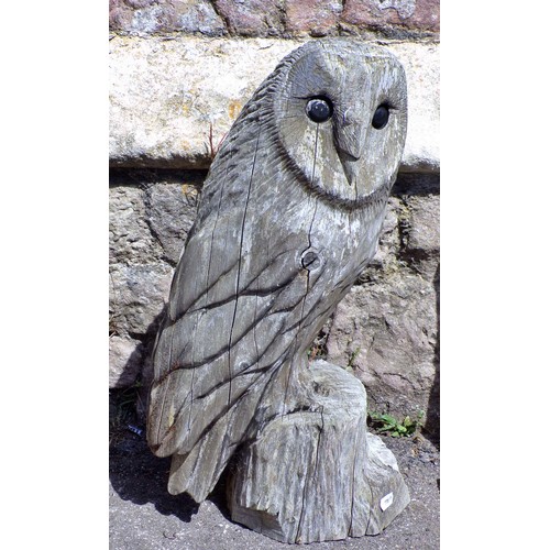 1120 - Two weathered carved wooden studies of barn owls, the largest 82cm high.