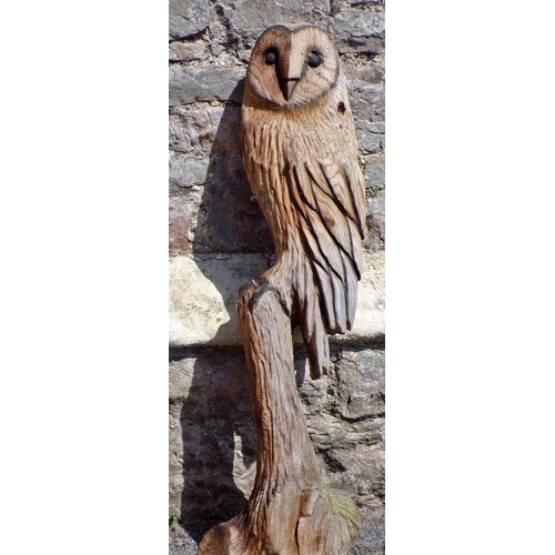 1120 - Two weathered carved wooden studies of barn owls, the largest 82cm high.