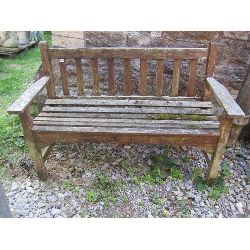 1070 - A small weathered stained teakwood garden bench, 82cm high, 128cm wide.