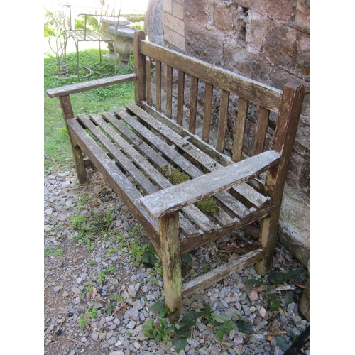 1070 - A small weathered stained teakwood garden bench, 82cm high, 128cm wide.