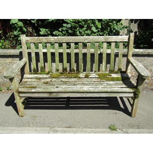 1072 - A large weathered teakwood garden bench with slatted back and seat, 95 x 163.