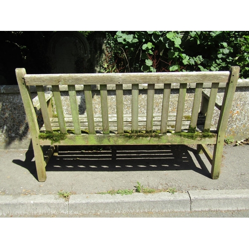 1072 - A large weathered teakwood garden bench with slatted back and seat, 95 x 163.