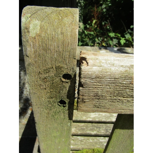 1072 - A large weathered teakwood garden bench with slatted back and seat, 95 x 163.